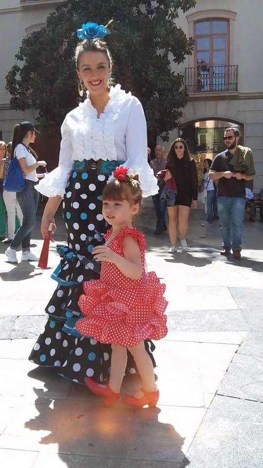 Mother and daughter in traditional Andalusian dress.